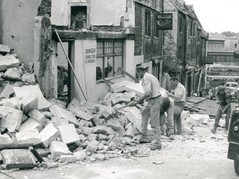 Workmen Cleaning a Slum Building