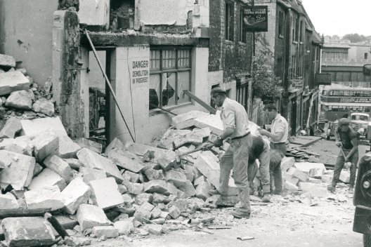 Workmen clearing premises at Holloway for redevelopment, 1950s.